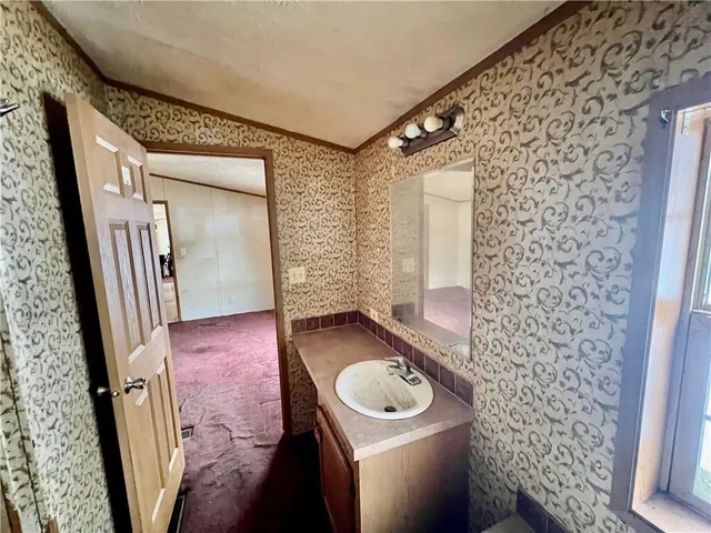 a bathroom with a granite countertop sink toilet a mirror and shower