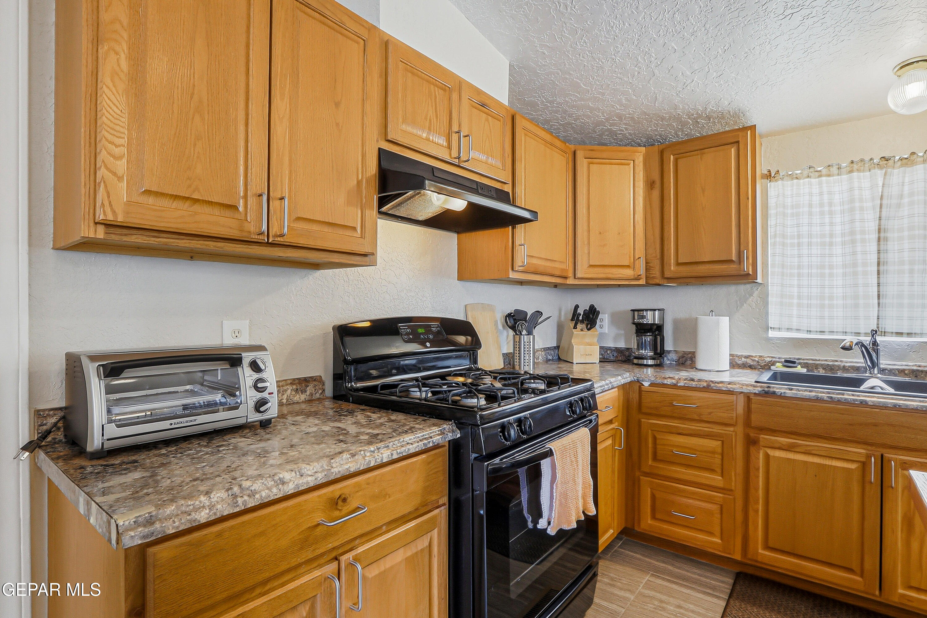 2901 Cook Street Truth or Consequences, NM 87901 - Photo 6 of 31 a kitchen with stainless steel appliances granite countertop a stove a sink and a microwave
