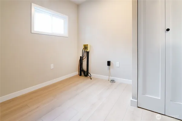 a view of a room with wooden floor and a ceiling fan
