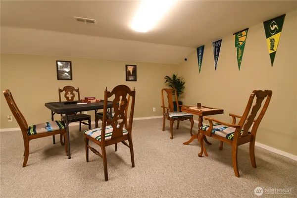 a view of a dining room with furniture and a table