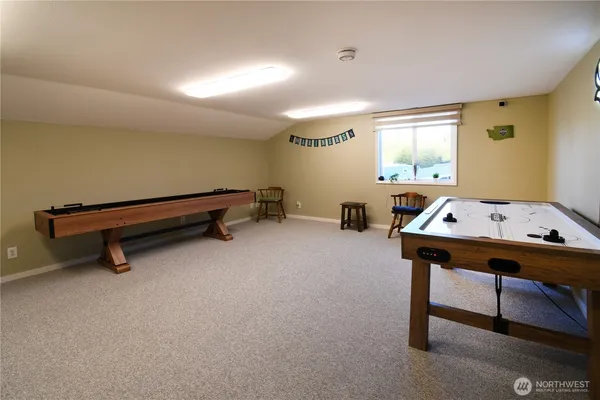 a room with furniture pool table and windows