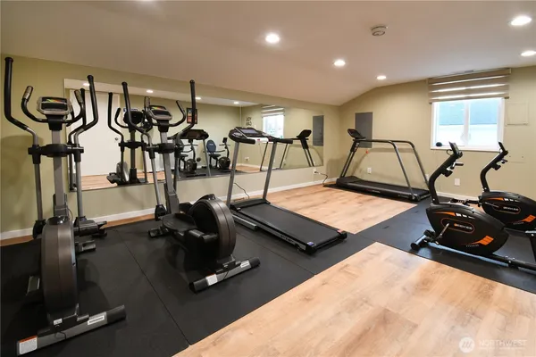 a room with gym equipment and windows