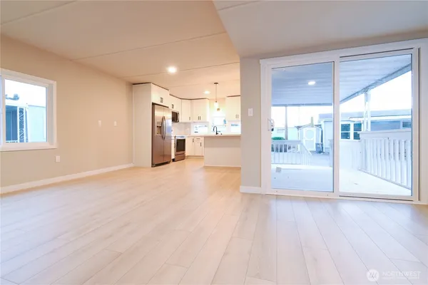 a view of a big room with wooden floor and outdoor space