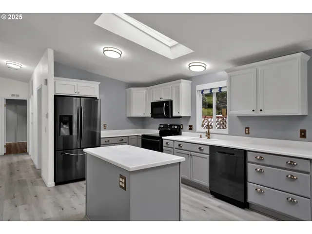 a kitchen with a sink stainless steel appliances and cabinets