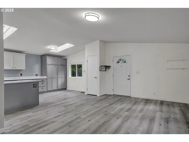 a view of a kitchen with wooden floor