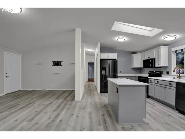 a open kitchen with cabinets stove and refrigerator