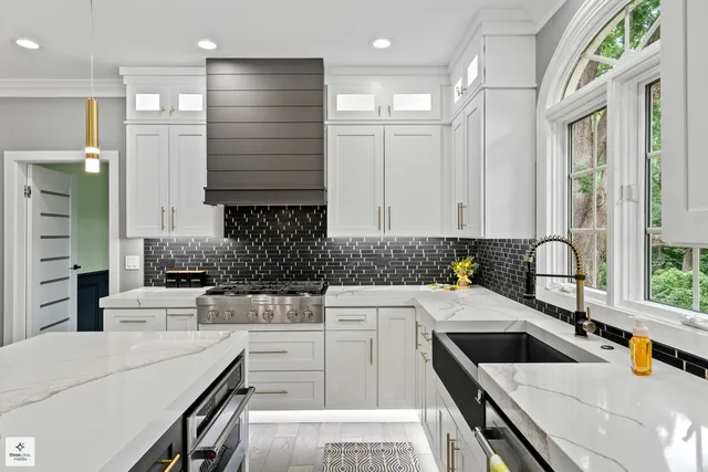 a kitchen with a sink a stove and cabinets