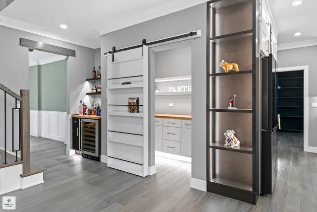 a kitchen with stainless steel appliances a refrigerator and wooden floor