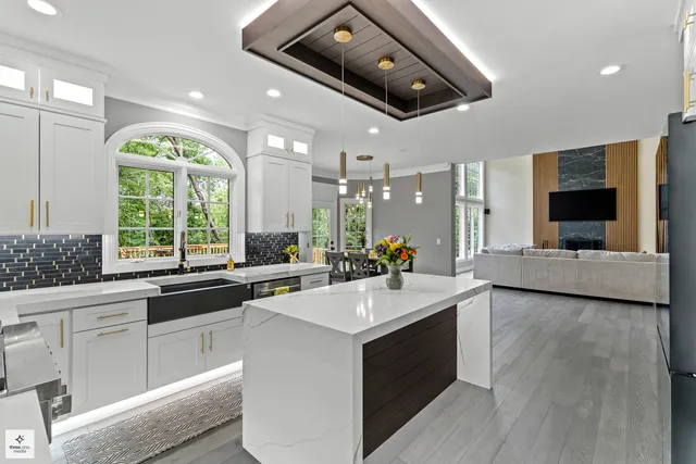 a large white kitchen with a large window