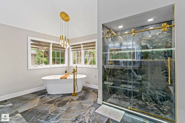 a room with a large window and chandelier