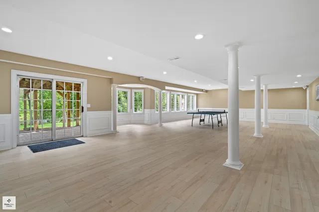 a view of an empty room with glass door and windows