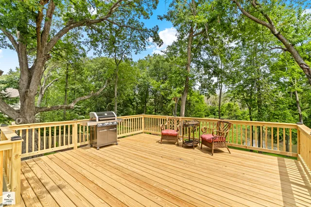 a view of a deck with chairs and wooden floor