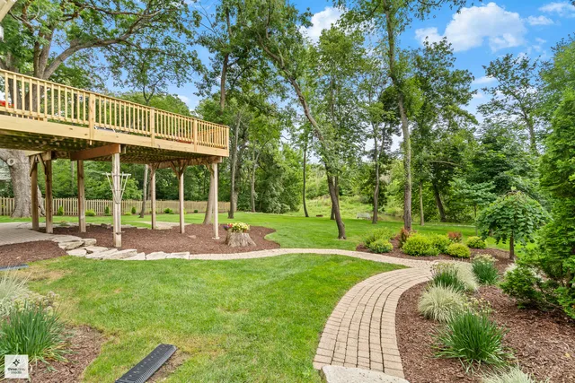 a view of a house with backyard and sitting area