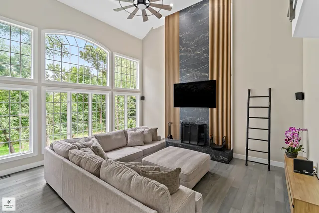 a living room with fireplace furniture and a flat screen tv
