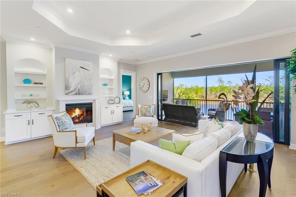 a living room with fireplace furniture and a large window