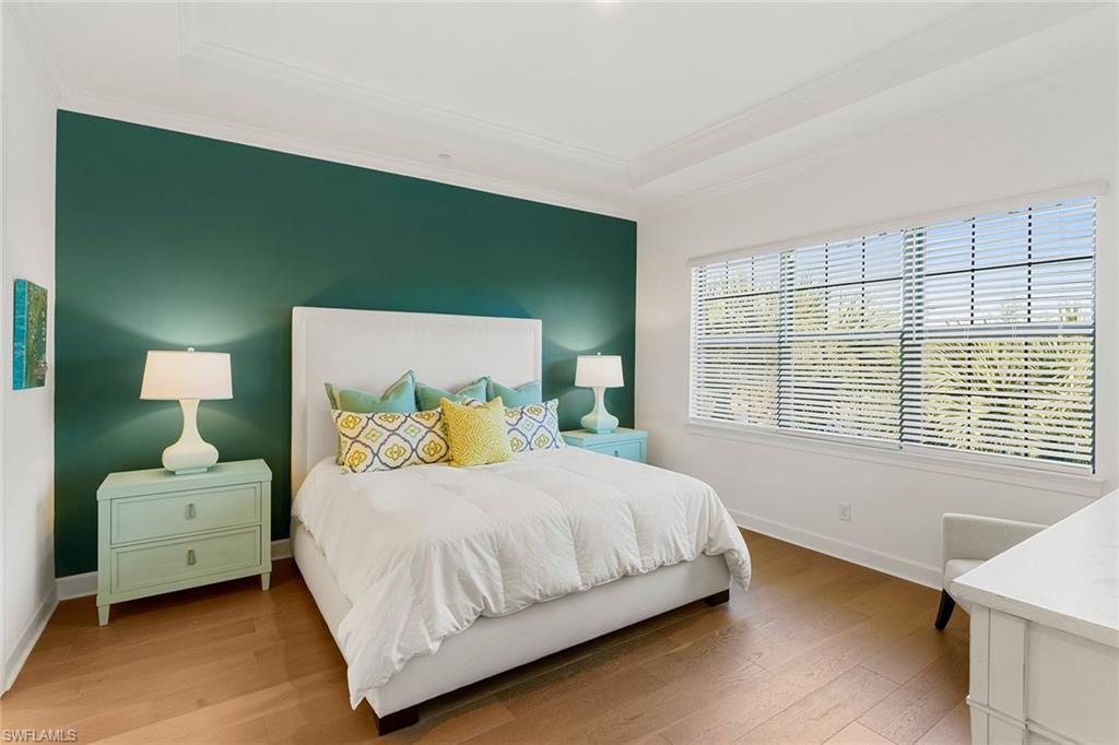 9633 Montelanico Loop, Unit 203 Naples, FL 34119 - Photo 15 of 33 a bedroom with a bed and a large window
