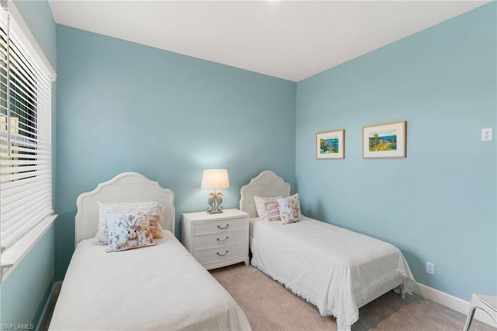 9633 Montelanico Loop, Unit 203 Naples, FL 34119 - Photo 20 of 33 a bedroom with bed and a window