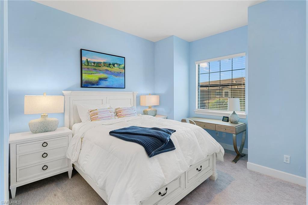 9633 Montelanico Loop, Unit 203 Naples, FL 34119 - Photo 21 of 33 a bedroom with a bed and a window