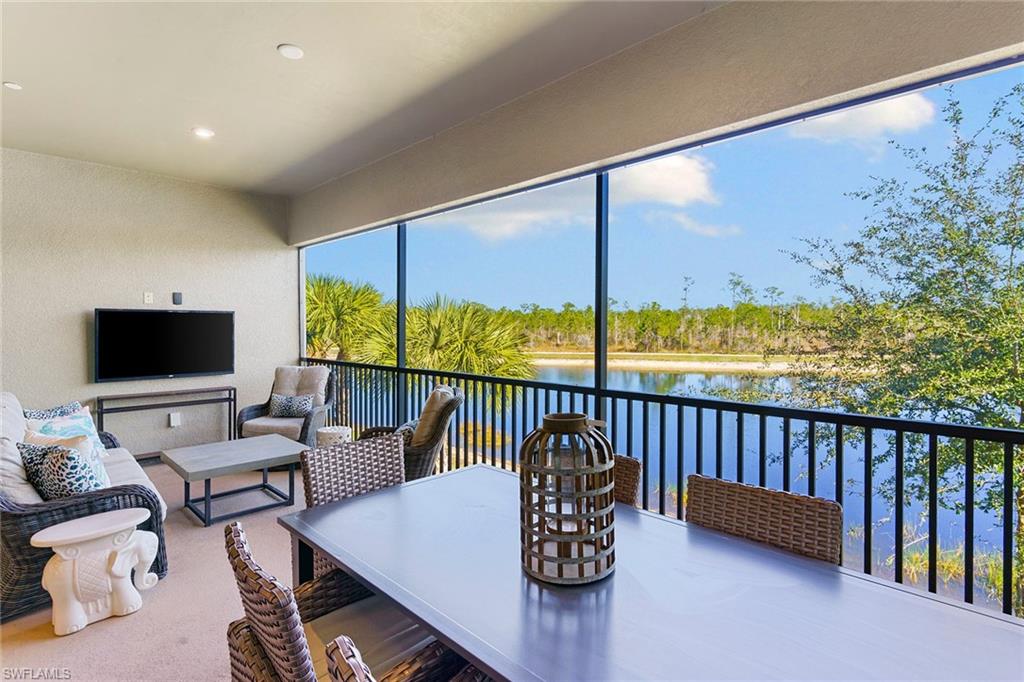 9633 Montelanico Loop, Unit 203 Naples, FL 34119 - Photo 26 of 33 a living room with furniture and a large window