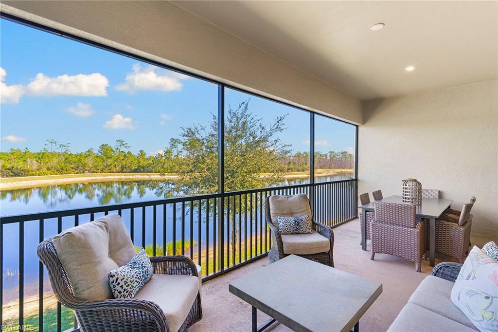 9633 Montelanico Loop, Unit 203 Naples, FL 34119 - Photo 27 of 33 a balcony with furniture