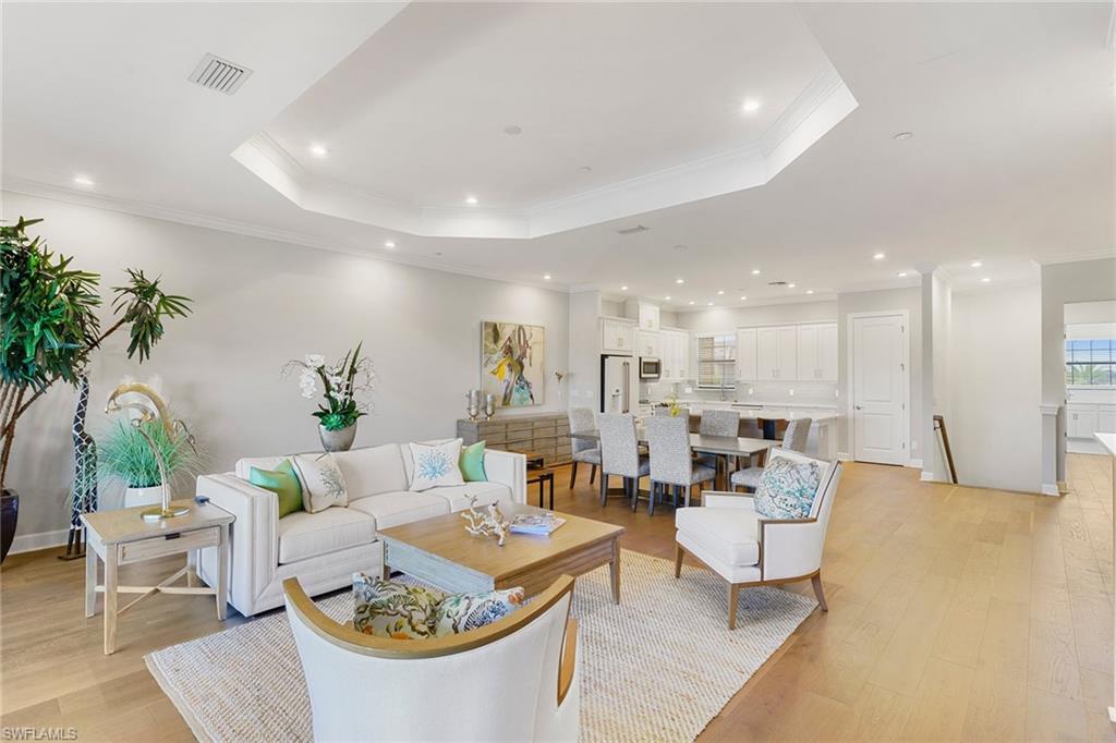 9633 Montelanico Loop, Unit 203 Naples, FL 34119 - Photo 3 of 33 a living room with furniture kitchen and a potted plant
