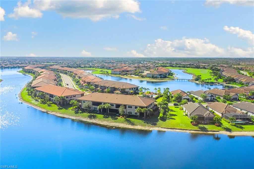 9633 Montelanico Loop, Unit 203 Naples, FL 34119 - Photo 31 of 33 an aerial view of a house with a swimming pool lake view and mountain view
