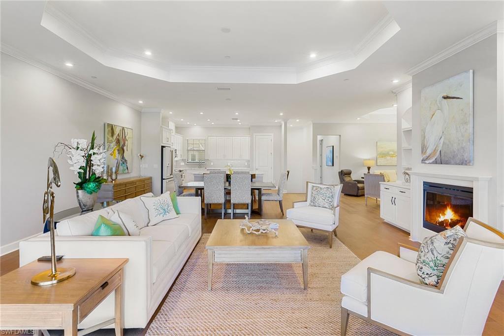 9633 Montelanico Loop, Unit 203 Naples, FL 34119 - Photo 4 of 33 a living room with fireplace furniture and a fireplace