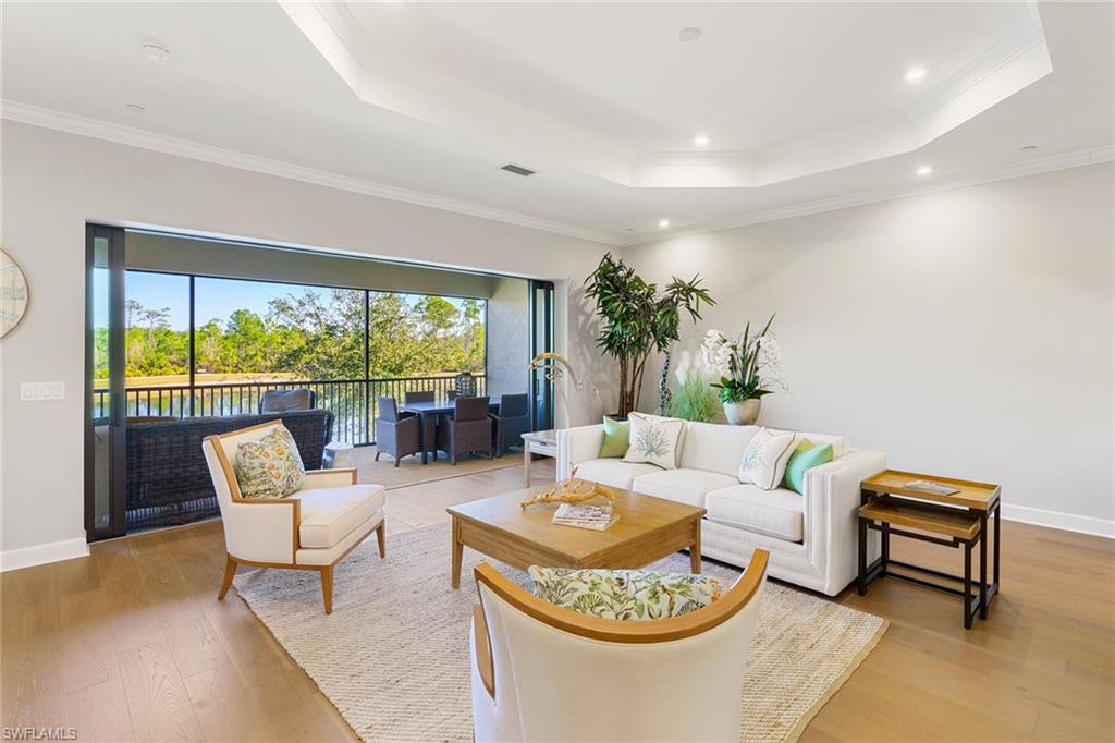 9633 Montelanico Loop, Unit 203 Naples, FL 34119 - Photo 6 of 33 a living room with furniture and a large window