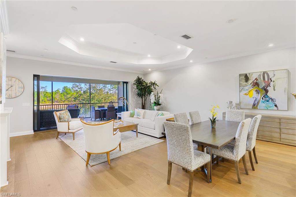 9633 Montelanico Loop, Unit 203 Naples, FL 34119 - Photo 7 of 33 a living room with fireplace furniture and a large window