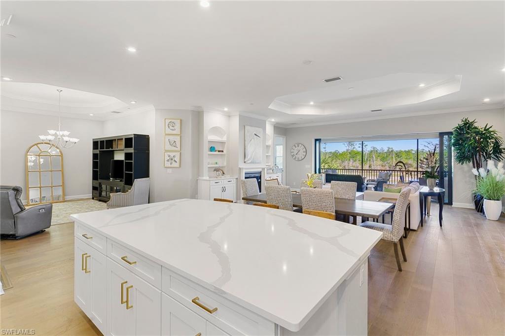 9633 Montelanico Loop, Unit 203 Naples, FL 34119 - Photo 9 of 33 a large white kitchen with a large window and stainless steel appliances