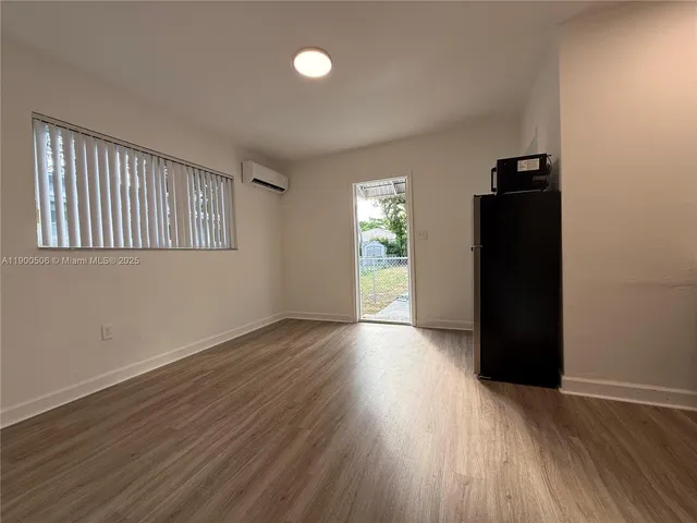 an empty room with wooden floor and closet