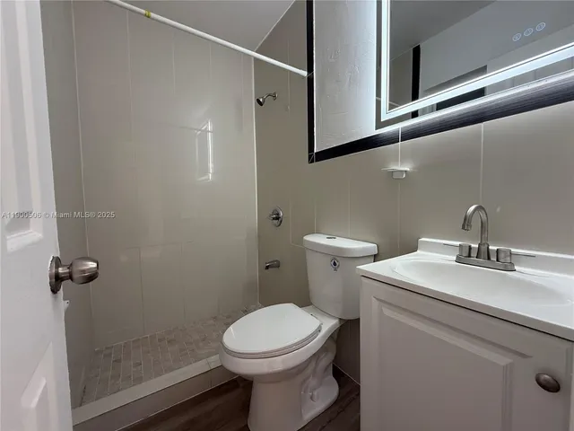 a bathroom with a sink toilet and shower