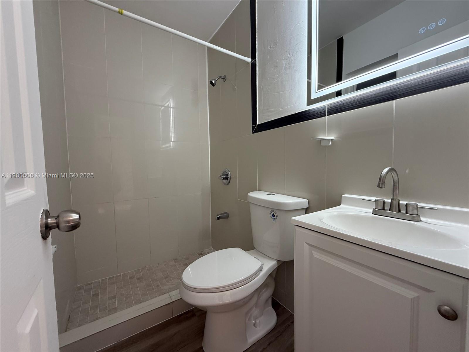 1120 Northwest 32nd Court, Unit BACK Miami, FL 33125 - Photo 8 of 10 a bathroom with a sink toilet and shower