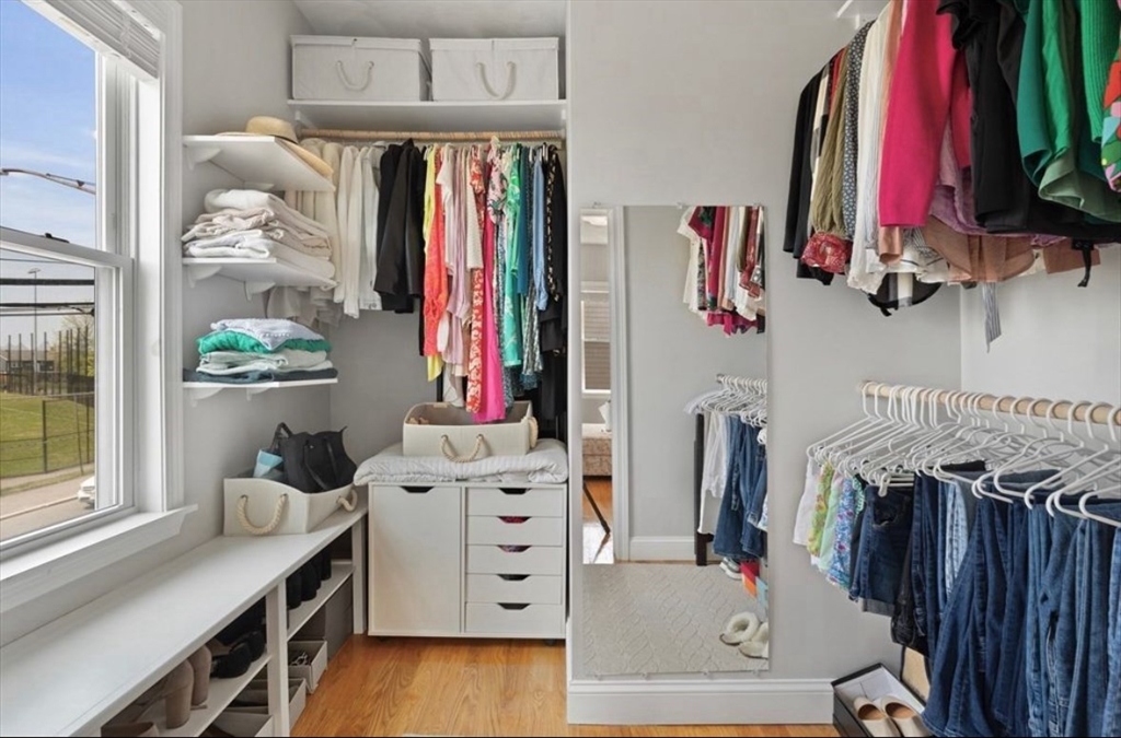 41 Boardman Street, Unit 2 Boston, MA 02128 - Photo 4 of 10 a view of walk in closet with clothes and shoes