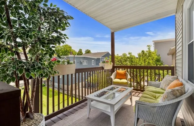 a view of a chairs and table in the balcony