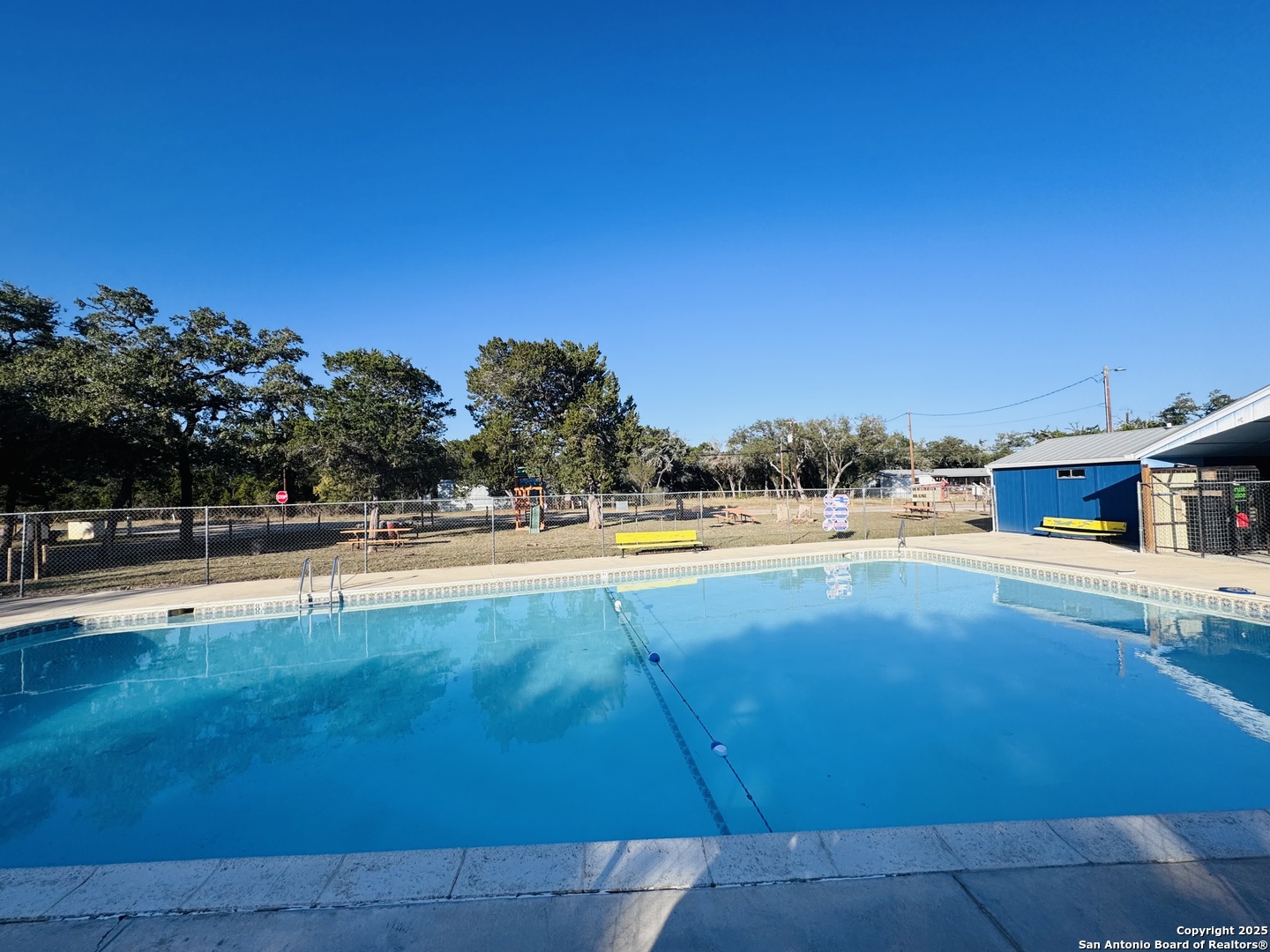 205 Center Point Road Bandera, TX 78003 - Photo 17 of 25 a view of swimming pool with outdoor seating and yard in back