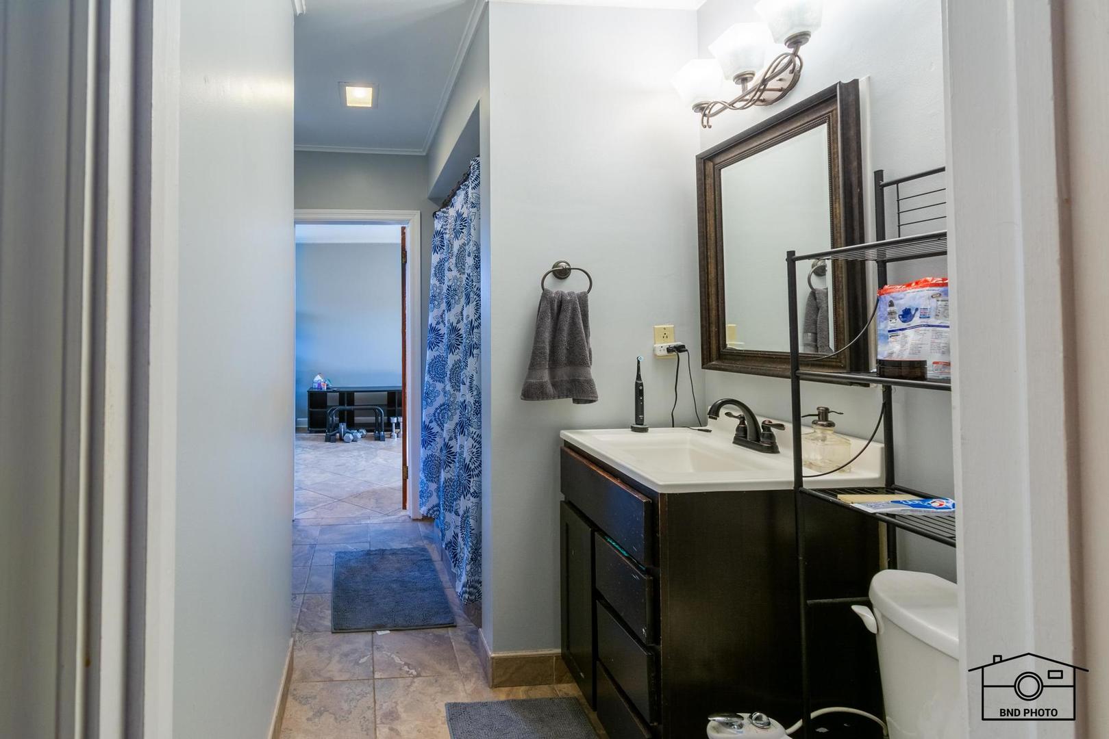 17617 Washington Avenue Homewood, IL 60430 - Photo 11 of 16 a en suite bathroom with a sink vanity and mirror