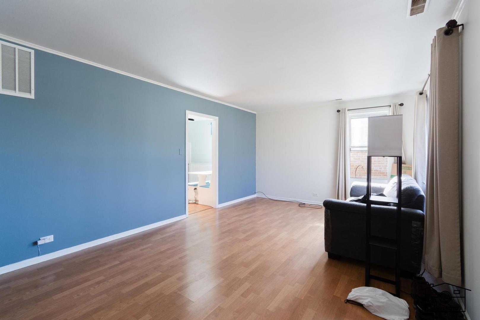17617 Washington Avenue Homewood, IL 60430 - Photo 3 of 16 a view of a workspace with wooden floor and a cabinet