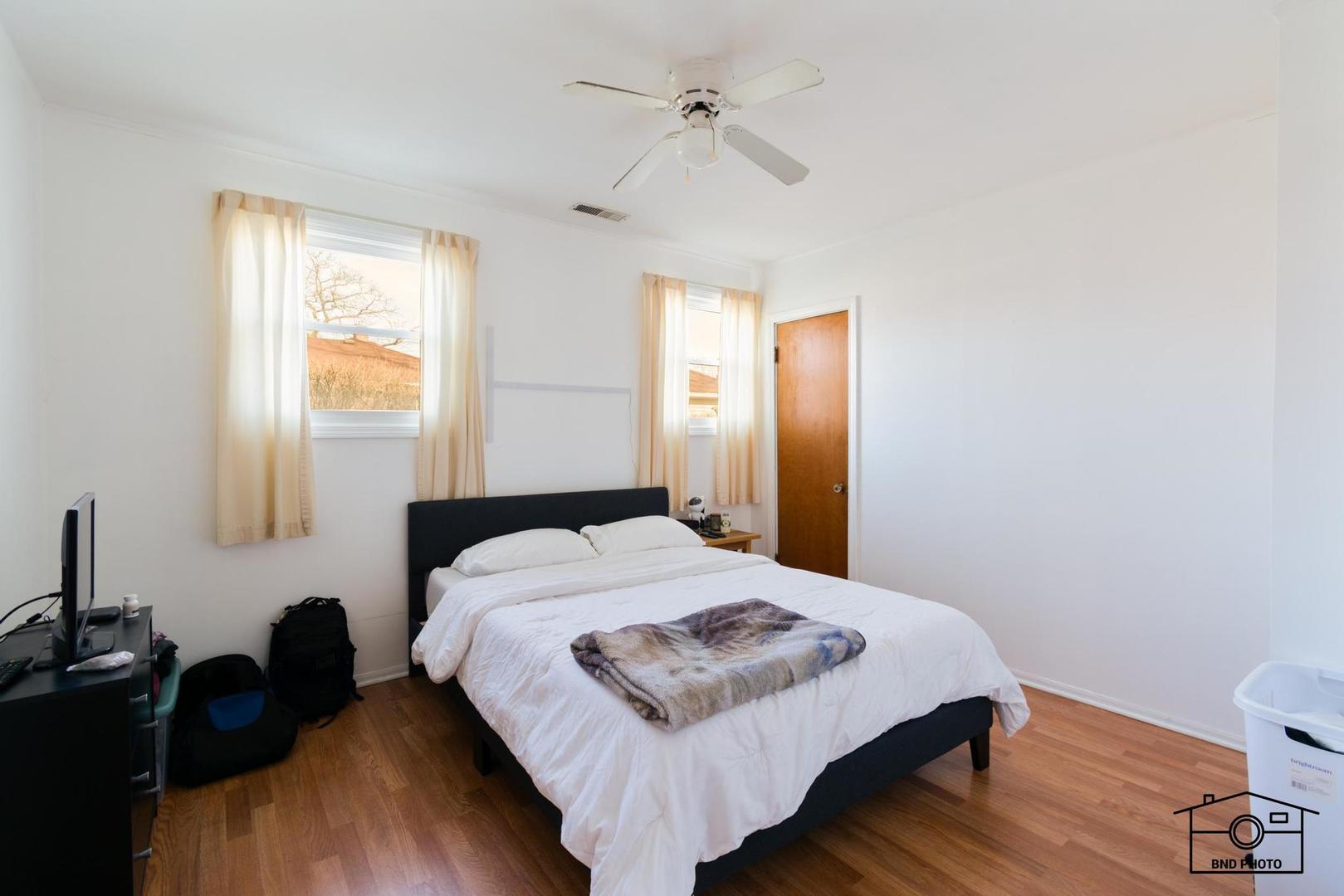 17617 Washington Avenue Homewood, IL 60430 - Photo 6 of 16 a bedroom with a bed and wooden floor