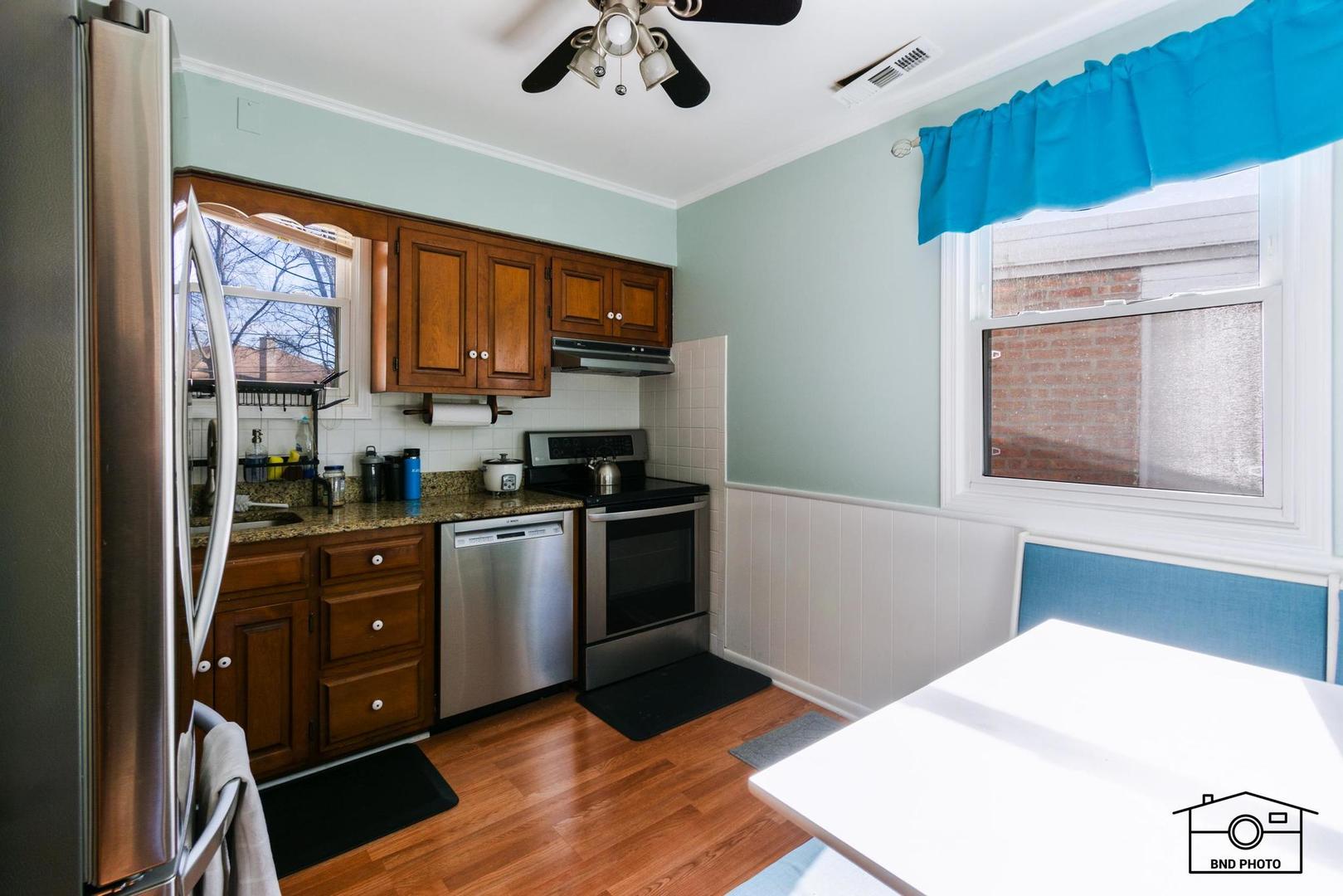 17617 Washington Avenue Homewood, IL 60430 - Photo 7 of 16 a kitchen with a refrigerator a stove and a window