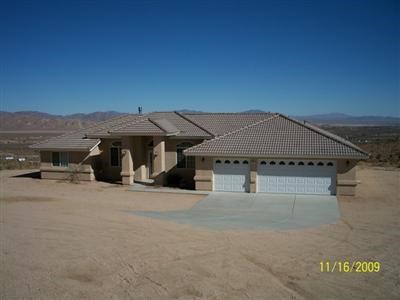 8790 Kinglet Road Apple Valley, CA 92308 - Photo 1 of 1 a view of a house with roof and a big yard