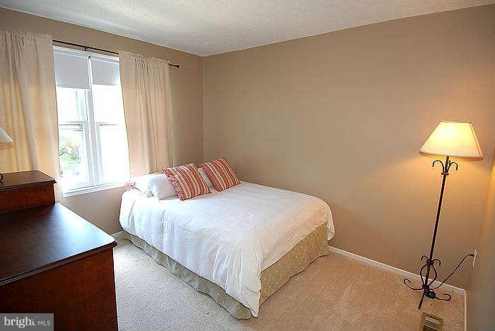 173 West Annandale Road Falls Church, VA 22046 - Photo 11 of 25 a bedroom with a bed and a lamp