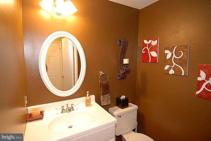 173 West Annandale Road Falls Church, VA 22046 - Photo 8 of 25 a bathroom with a sink mirror and toilet