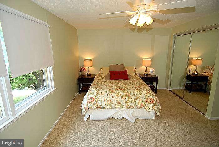 173 West Annandale Road Falls Church, VA 22046 - Photo 9 of 25 a spacious bedroom with a bed and a chandelier