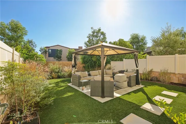 a backyard of a house with yard fountain and outdoor seating