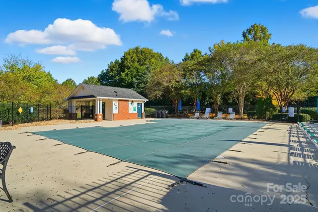 a view of a patio with a table and chairs under an umbrella
