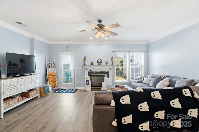 a living room with furniture fireplace and flat screen tv