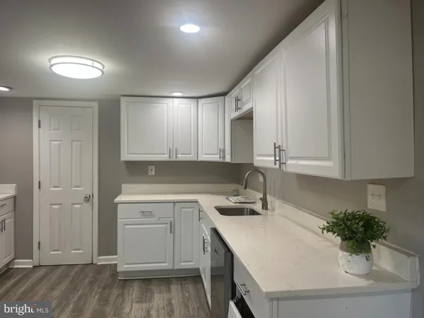 a kitchen with a sink and cabinets