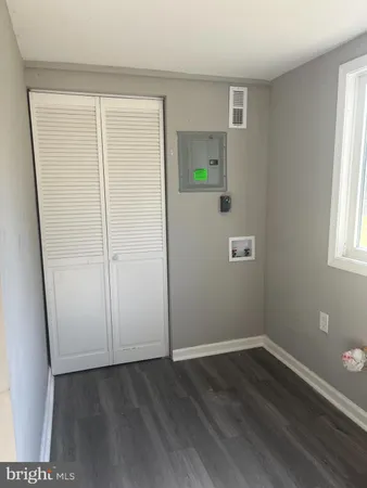 an empty room with windows and closet