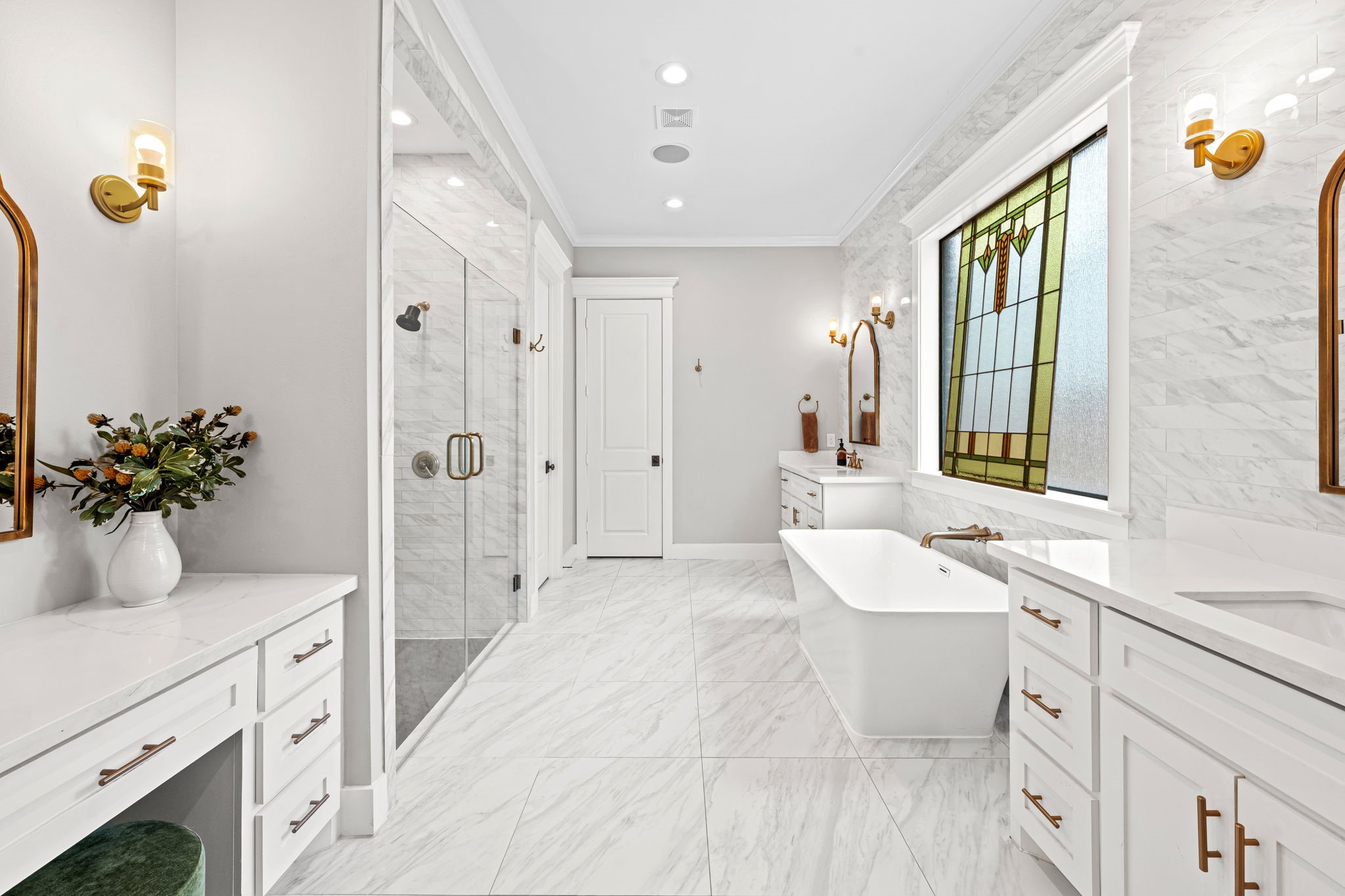 1013 Martin Street Houston, TX 77018 - Photo 22 of 46 Lavish primary bath featuring dual vanities, additional makeup vanity space, freestanding soaking tub, statement tile wall behind vanities. Door straight ahead leads to a massive walk-in closet.